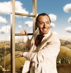 A smiling man in a light suit and patterned scarf holds a wooden ladder against a whimsical, illustrated landscape with hills, tiny trees, and puffy clouds in the background.