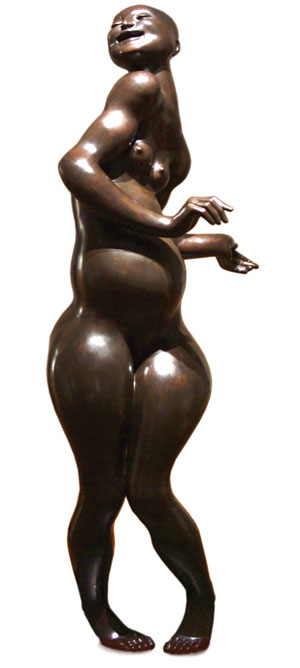 A bronze sculpture of a nude woman with a curvy body standing on tiptoe, her arms bent and hands gesturing gracefully, with a joyful expression on her face.