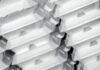Stacks of white styrofoam food containers arranged in a diagonal pattern, creating a repetitive and orderly design.