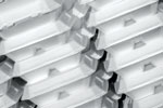 Stacks of white styrofoam food containers arranged in a diagonal pattern, creating a repetitive and orderly design.