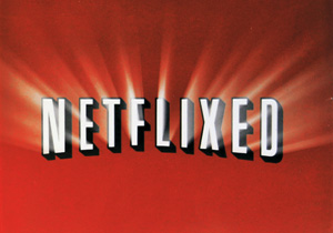 The image shows the word NETFLIXED in bold, white, 3D-style letters against a red background, resembling the classic Netflix logo with rays of light shining out from behind the letters.