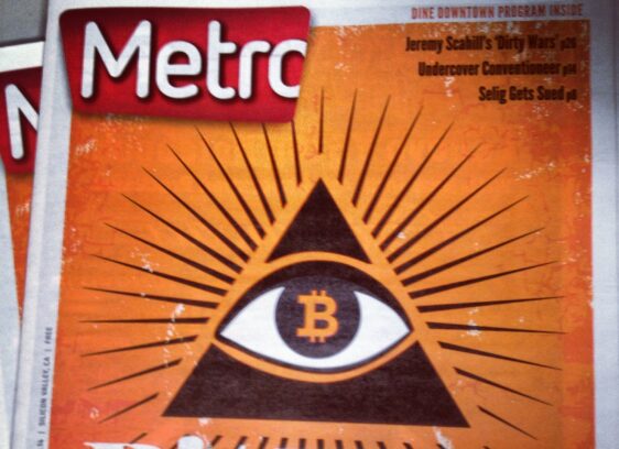 A Metro newspaper cover features an illustrated pyramid with an eye and a Bitcoin symbol in the center, radiating lines. The headline reads “Bit Play: Get Ready for the Ultimate Disruption: The Reinvention of Money.”.
