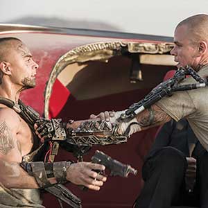 Two men with mechanical exoskeletons and weapons engage in a tense confrontation in front of a damaged red vehicle, both appearing intense and ready to fight.