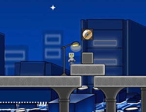 A small robot stands on a platform under a streetlamp in a blue, nighttime cityscape. There is a box and a floating item next to the robot, with buildings and a star visible in the background.