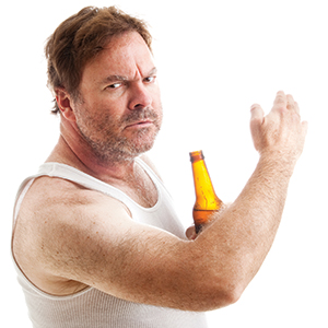 A middle-aged man in a white tank top holds a beer bottle and looks angrily at the camera while raising his hand, as if gesturing or waving someone off. The background is white.