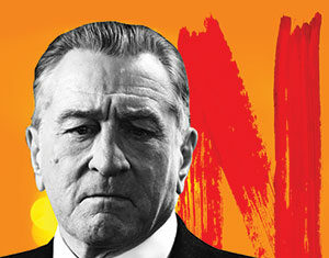 A serious-looking man in a suit and tie is shown in black and white, with an orange background featuring a large red N resembling the Netflix logo.