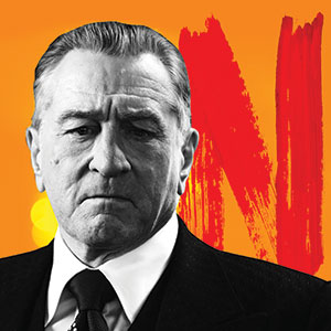 A serious-looking man in a suit and tie is shown in black and white, with an orange background featuring a large red N resembling the Netflix logo.