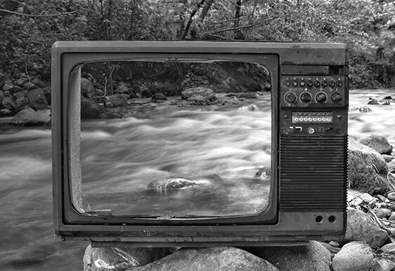 Hollow TV screen with a river behind it