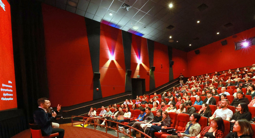 Crowd in a theater with two men on stage