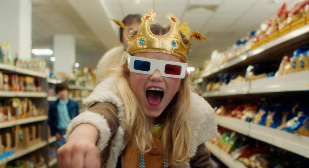 Young girl in store looking at the camera and wearing 3D glasses