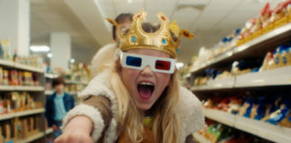 Young girl in store looking at the camera and wearing 3D glasses