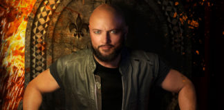 Photo of man in a chair staring intently into the camera