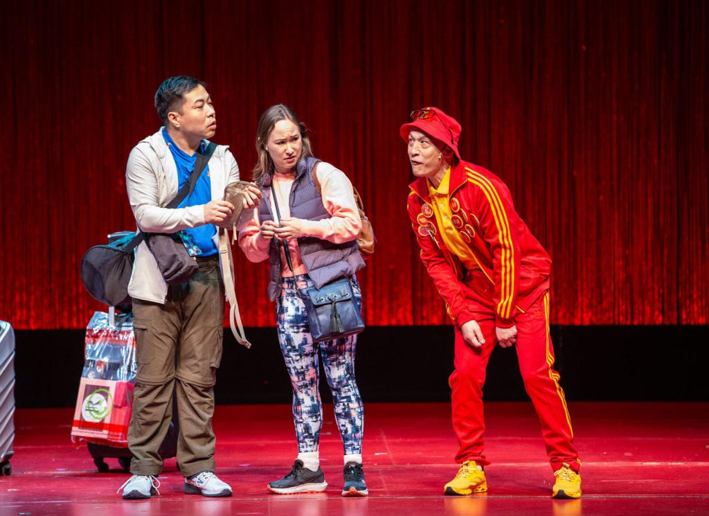Three people standing on a stage