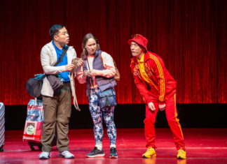 Three people standing on a stage