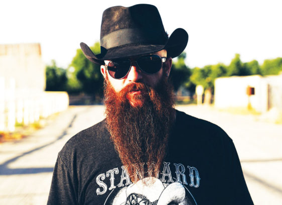 Man with a long beard wearing a black hat and black T-shirt