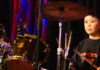 Young boy sitting behind a drum kit