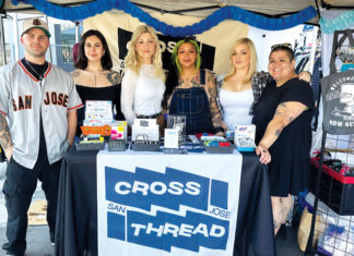 Six people pose in their booth