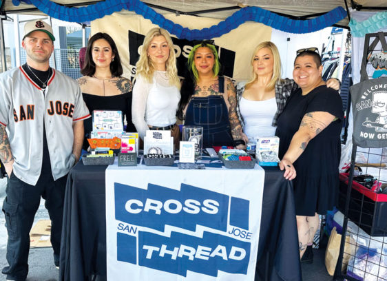 Six people pose in their booth