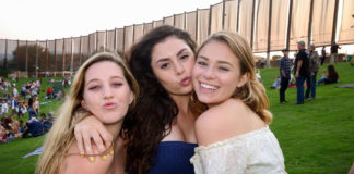 Three concert-goers outdoors posing for a picture