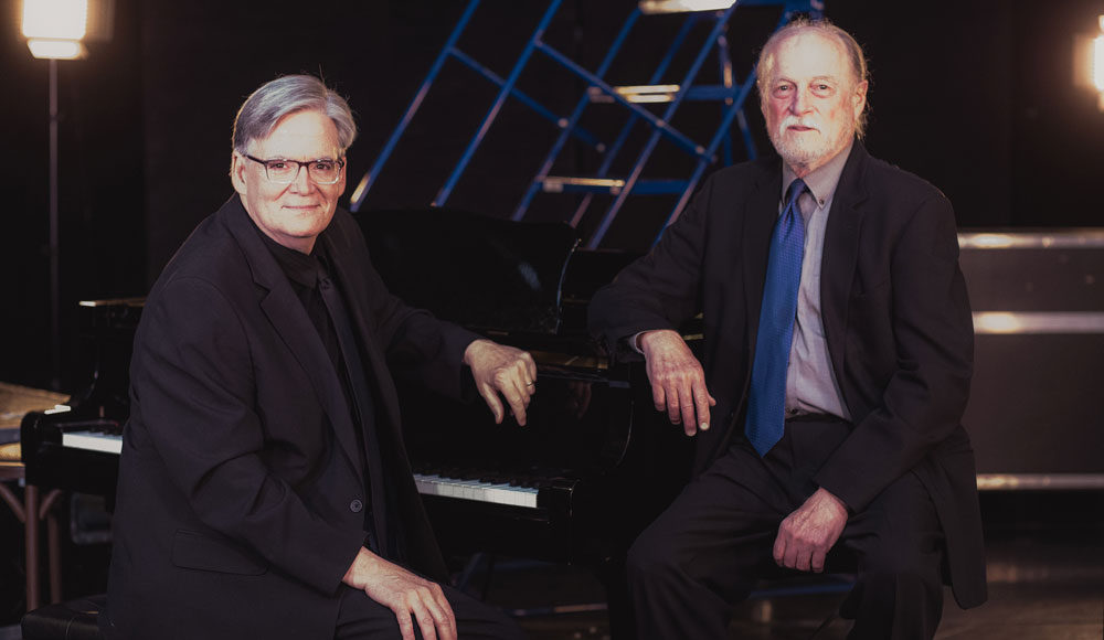 Two men sitting on a stage