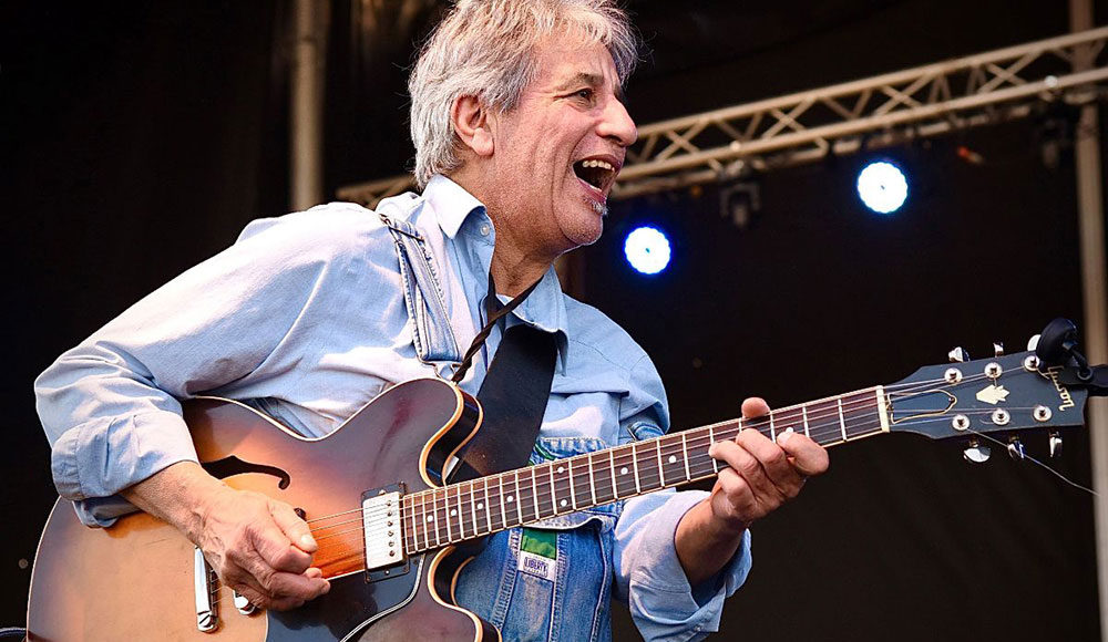 Man playing the guitar on stage