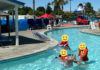 Photo of people at a water park with smiley-face heads grafted onto the bodies
