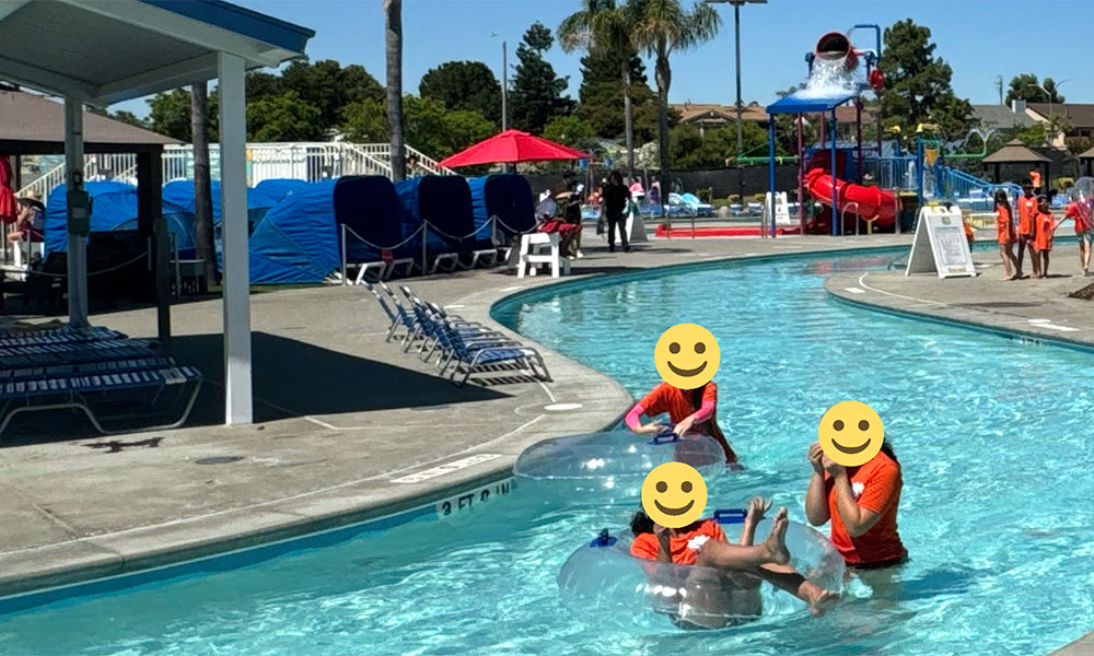 Photo of people at a water park with smiley-face heads grafted onto the bodies