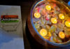Ambrosia India Bistro menu next to floating candles and rose petals
