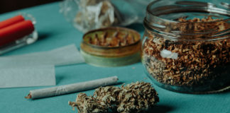 Marijuana buds and a joint sitting on a tabletop