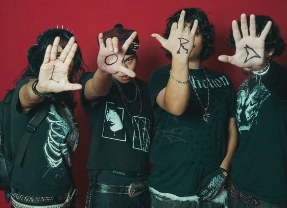 Musicians with faces covered by their open palms, with letters written on them that spell out LORD