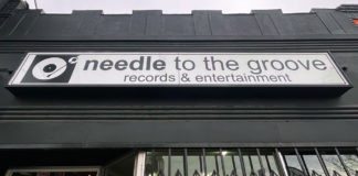 Needle to the Groove storefront with sign