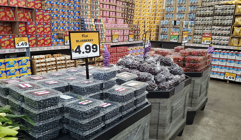 Grocery store display with blueberries surrounded by other shelves