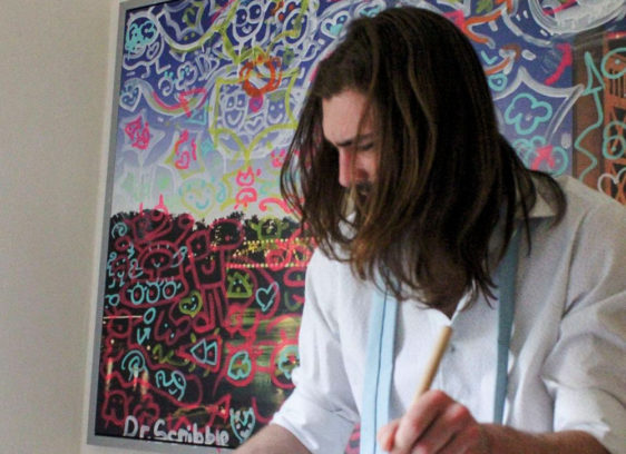 Man with his head looking down while he drums