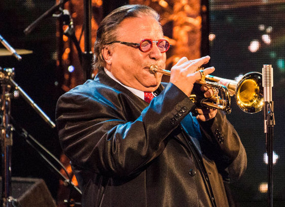 Man playing a trumpet onstage