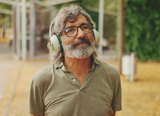 Man standing outside wearing headphones