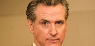 Man staring directly at the camera with a stern look on his face