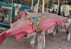 Salmon-shaped seat on a dusty, out-of-commission carousel