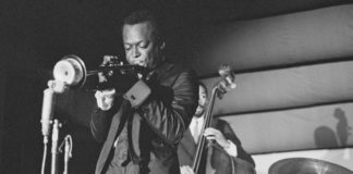 Man playing trumpet on a stage; black-and-white archival photo