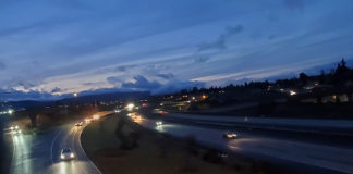 Freeway at twilight, cars driving with headlights