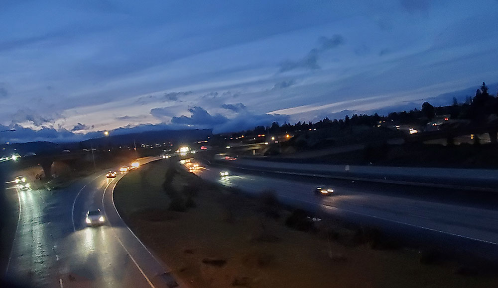 Freeway at twilight, cars driving with headlights
