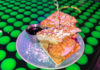 Plate with chicken and waffles on top of a table decorated with neon green golf balls