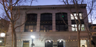 Photo of a building on a ciy street at dusk