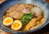 Big bowl of noodles,eggs,meat and garnishes