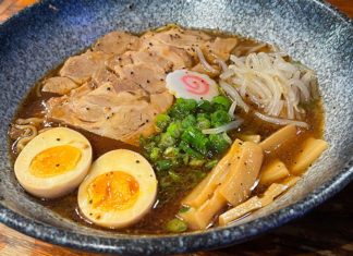 Big bowl of noodles,eggs,meat and garnishes