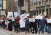 Protestors holding signs on a city street