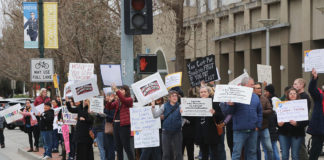 Protestors holding signs on a city street