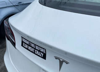 Tesla with an anti-Musk bumper sticker