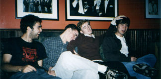 Four people sitting on a couch