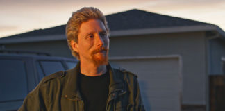 Man standing outside in front of a house