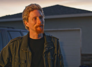 Man standing outside in front of a house